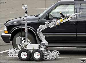 A robot examines a suspect vehicle in a car park