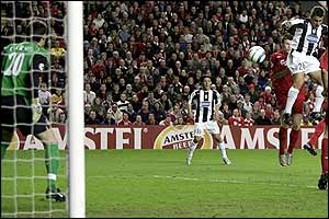 Fabio Cannavaro leaps to head the ball