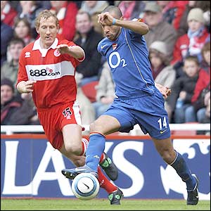 Arsenal striker Thierry Henry dribbles into the danger area as Ray Parlour tries to block his progress
