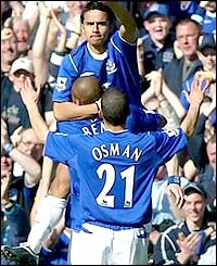 Tim Cahill is held aloft to salute the fans after putting Everton 2-0 up
