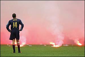 Inter's Juan Sebastian Veron can only watch as a bewildering amount of flares and bottle rain onto the San Siro pitch