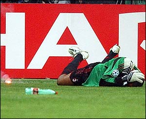 AC Milan goalkeeper Dida lies injured after being struck by a flare