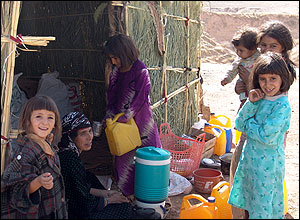 Young girls standing by their home in Dareh Shahr
