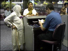Two Asian women at passport control at UK airport