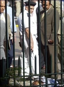 Security officers examine a body at the site of the blast behind the Egyptian museum in Cairo.