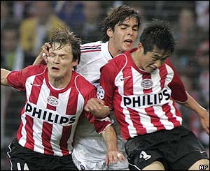 Milan's Kaka duels for the ball with PSV players Johann Vogel and Young-Pyo Lee