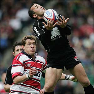 Saracens' Thomas Castaignede gathers the ball under pressure from James Forrester of Gloucester in the Zurich Wildcard final