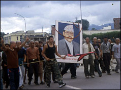 Young Nepalese men hold up image of the murdered king