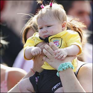 A baby girl watches the Liverpool parade