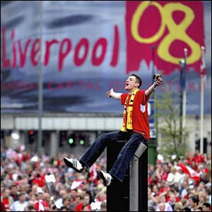A Liverpool fan perches on a lamp post
