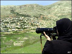 Syrian girl takes a photo of village on the occupied Golan Heights