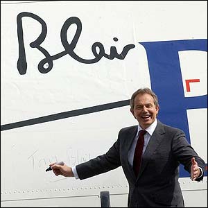 Prime Minister Tony Blair signs an aeroplane at a London 2012 photocall