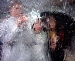 Arthur Rutson-Griffiths and his two sisters Lizzie and Florence in the fountain in Cardiff Bay outside the Millennium Centre