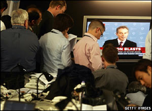 Members of the press watch Mr Blair