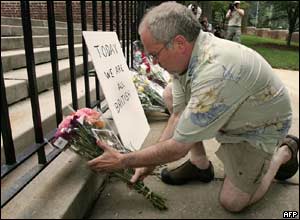 US citizen Geoffrey Forman, just back from a visit to London, places flowers on the steps of the British Embassy in Washington, DC
