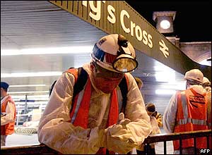 A construction worker bows his head in prayer at Kings Cross station in London