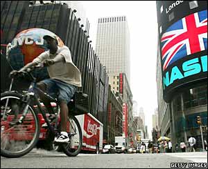 A cyclist passes the Nasdaq Marketsite in Times Square displaying a message of solidarity for London