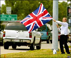 Robert Santurri, of Madison, Wisconsin, waves the union jack as traffic passes