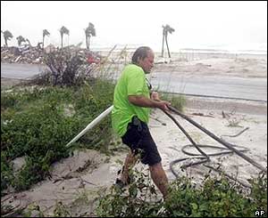 A Florida man works to secure a building on Pensacola Beach 