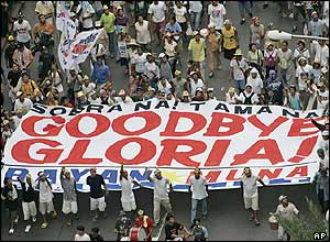 Protesters take part in a mass demonstration calling on Philippine President Gloria Arroyo (GMA) to resign, in the Makati financial district of Manila, 13 July 2005