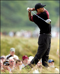 Tiger Woods tees off on the fourth