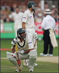 Jason Gillespie recovers after being hit by a Steve Harmison delivery