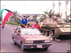 Kuwait city resident waves flag from top of car 