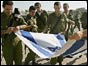Soldiers fold away Israeli flag