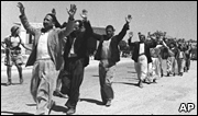 Palestinians march with raised hands during the surrender of the town of Ramle, in May 1948
