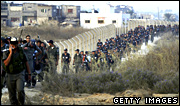 Israeli security forces head for Kfar Darom during the forced evacuation of settlements in the Gaza Strip in 2005