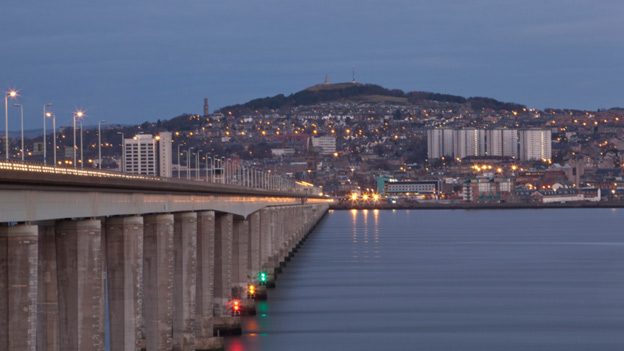 View along the Tay Bridge to Dundee, illuminated by lights from buildings and streetlights