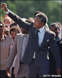 Nelson Mandela walks free from prison holding his fist aloft in the Black Power salute