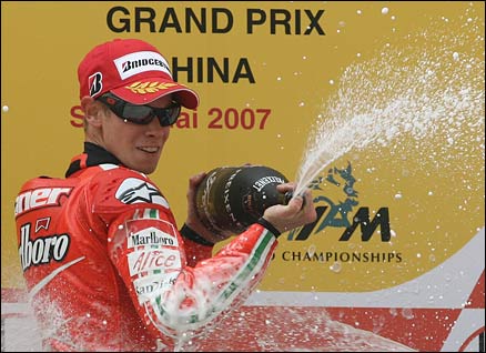 Australian rider Casey Stoner celebrates after winning the MotoGP race at the Grand Prix of China