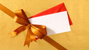 Close-up of a Christmas present, with a red bow and a gift tag