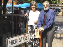 Shula Moreland and Sidney Morris by a road sign