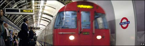 A London Underground 'Tube' train arrives into a station