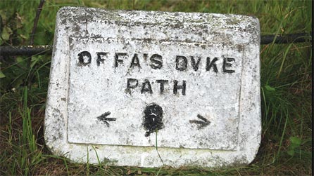 Stone sign marking the dyke route near Mellington House.