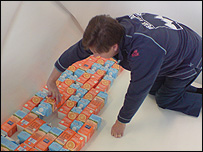 The boat is lined with orange juice cartons
