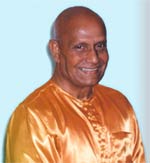 Sr Chinmoy in orange silky shirt