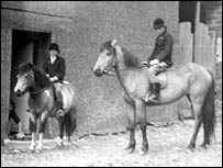 Two girls on horseback outside Frances' house