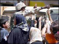 US Soldier handing out pens