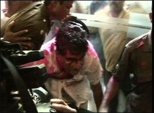 Minister Dr. Mervyn Silva being taken away by security forces