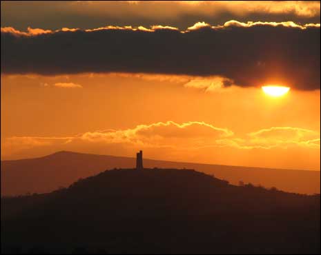 sun and clouds over castle hill