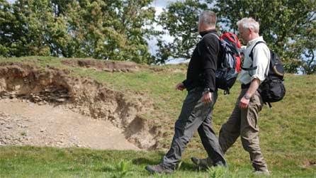 Derek and Jim walk past a section where livestock have eroded the sides.