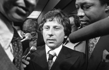 Roman Polanski surrounded by the press