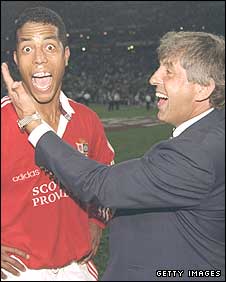 Ian McGeechan celebrates the 1997 Lions series victory in South Africa with Jeremy Guscott