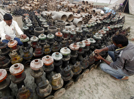 Indian workers check water pumps on the banks of the River Ganges