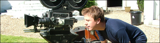 Reporter John Escolme operates a vintage film camera.