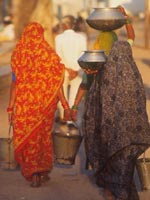 Asian women carrying water