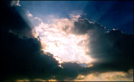 The sun appearing through Cumulus clouds